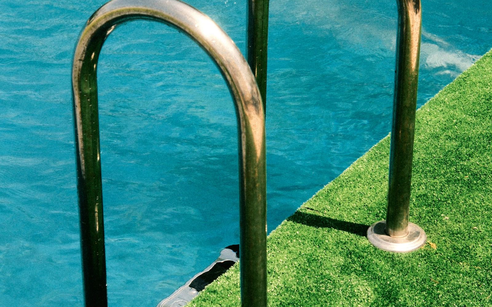 Artificial turf installed beside a swimming pool
